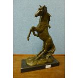 A bronze figure of a rearing stallion, on black marble plinth, 41cm