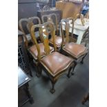 A set of four carved walnut dining chairs