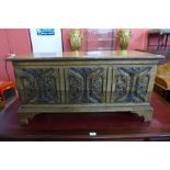 A 17th Century style carved oak blanket box, 47cms h, 94cms w, 37cms d.