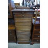 An oak tambour front filing cabinet