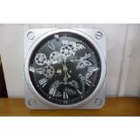 A contemporary circular skeleton wall clock