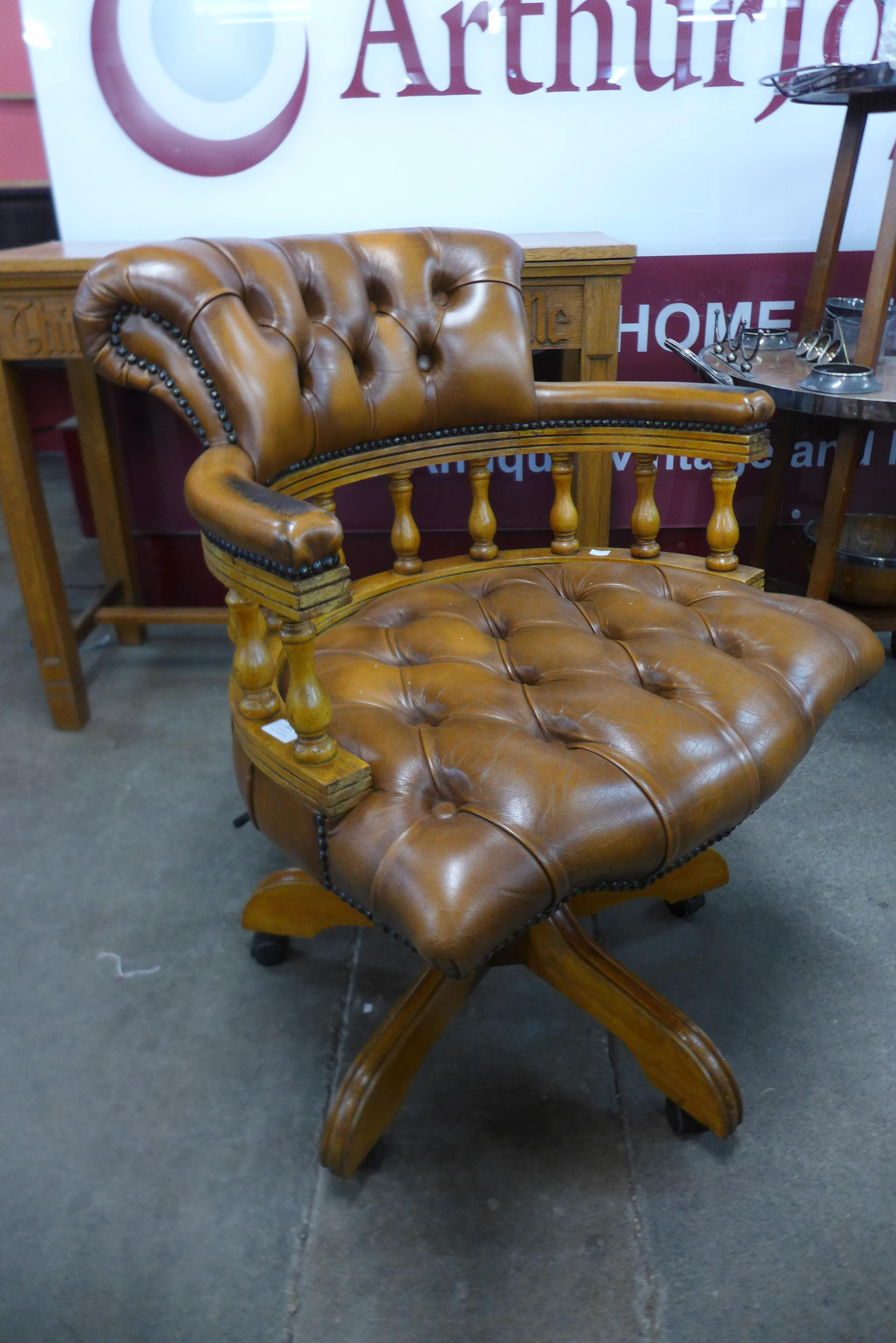 A mahogany and leather revolving desk chair