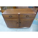 An Ercol Golden Dawn elm Windsor sideboard