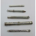 Four silver pencil holders including one Victorian and one larger white metal pencil holder, (