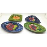 Moorcroft, four ashtrays in various Hibiscus patterns, all circa 1940-50s, a triangular ashtray,