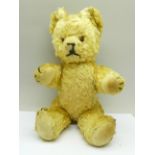 A jointed Teddy bear, with straw filled body, kapok filled head, arms and legs, blonde blush,