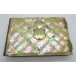 A late Victorian photograph album with mother of pearl and abalone cover, 23.5cm x 15cm, (some