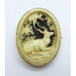 A Victorian 9ct gold memorial brooch with carved stag decoration, width 27mm