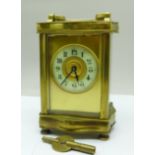 A French brass and glass carriage clock with key