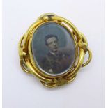 A Victorian gold plated swivel brooch, (with early photograph of a gentleman and a later image of