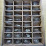 A small tray of pocket watch glasses