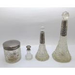 Three silver topped glass scent bottles and a silver topped glass jar