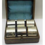 A cased set of six napkin rings with etched figures of a Victorian girl and boy