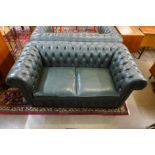 A green leather Chesterfield settee