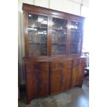 A George III style inlaid mahogany serpentine library bookcase