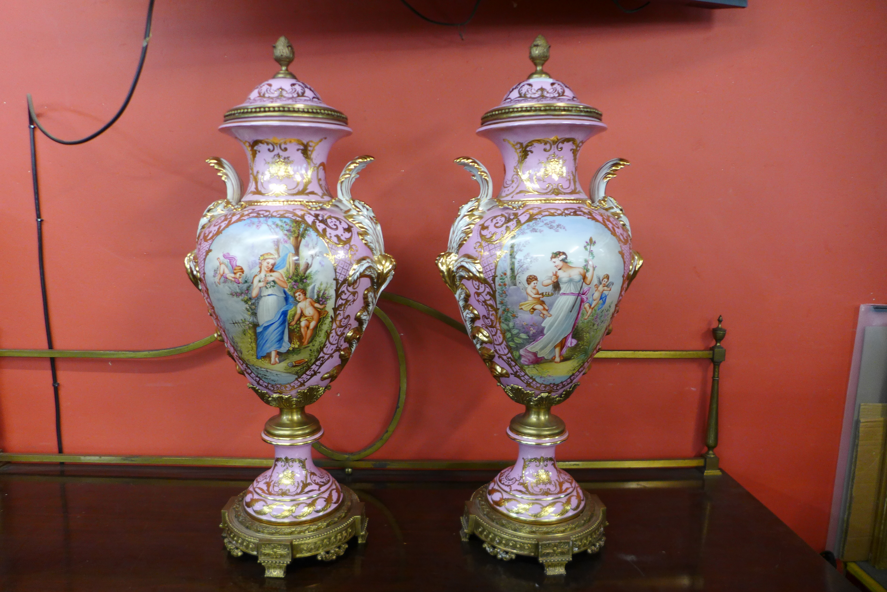 A pair of large French style pink porcelain and gilt metal mounted vases and covers, with gilded