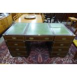 A campaign style mahogany, brass mounted and green leather topped desk