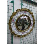 A Staffordshire Artmaster porcelain and gilt metal framed circular mirror