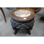 A small Chinese carved hardwood and marble topped jardiniere stand
