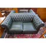 A green leather Chesterfield settee