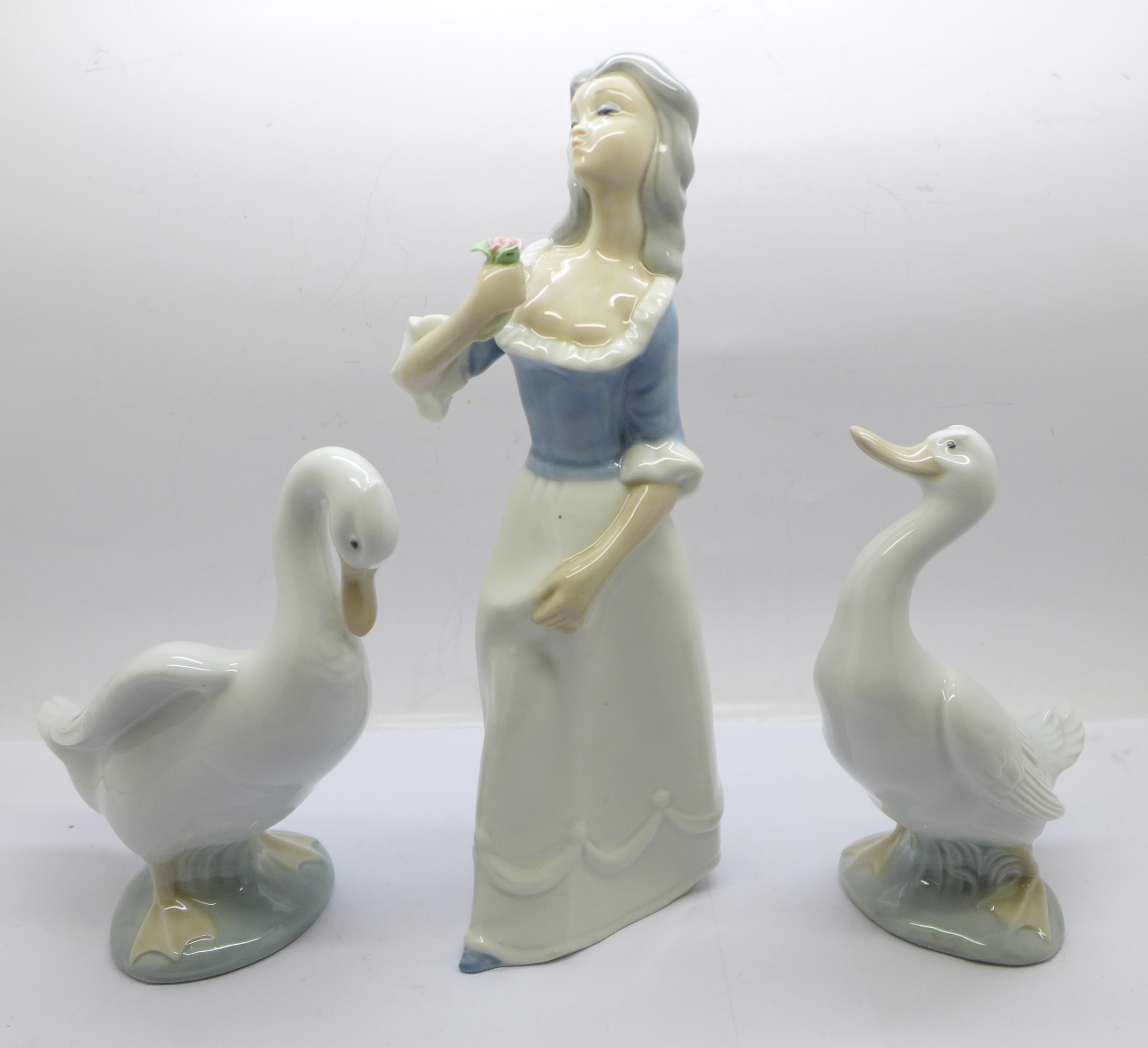 Two Nao by Lladro geese figures and a Spanish figure of a woman