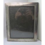 A white metal photograph frame, B.M.C. Ld., mark worn, 19cm x 24mm, (lacking stand)