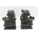 A pair of carved stone dogs of foe on marble plinths, 10.5cm, both a/f