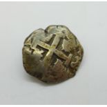 A silver coin converted into a brooch, possibly a Spanish Reale