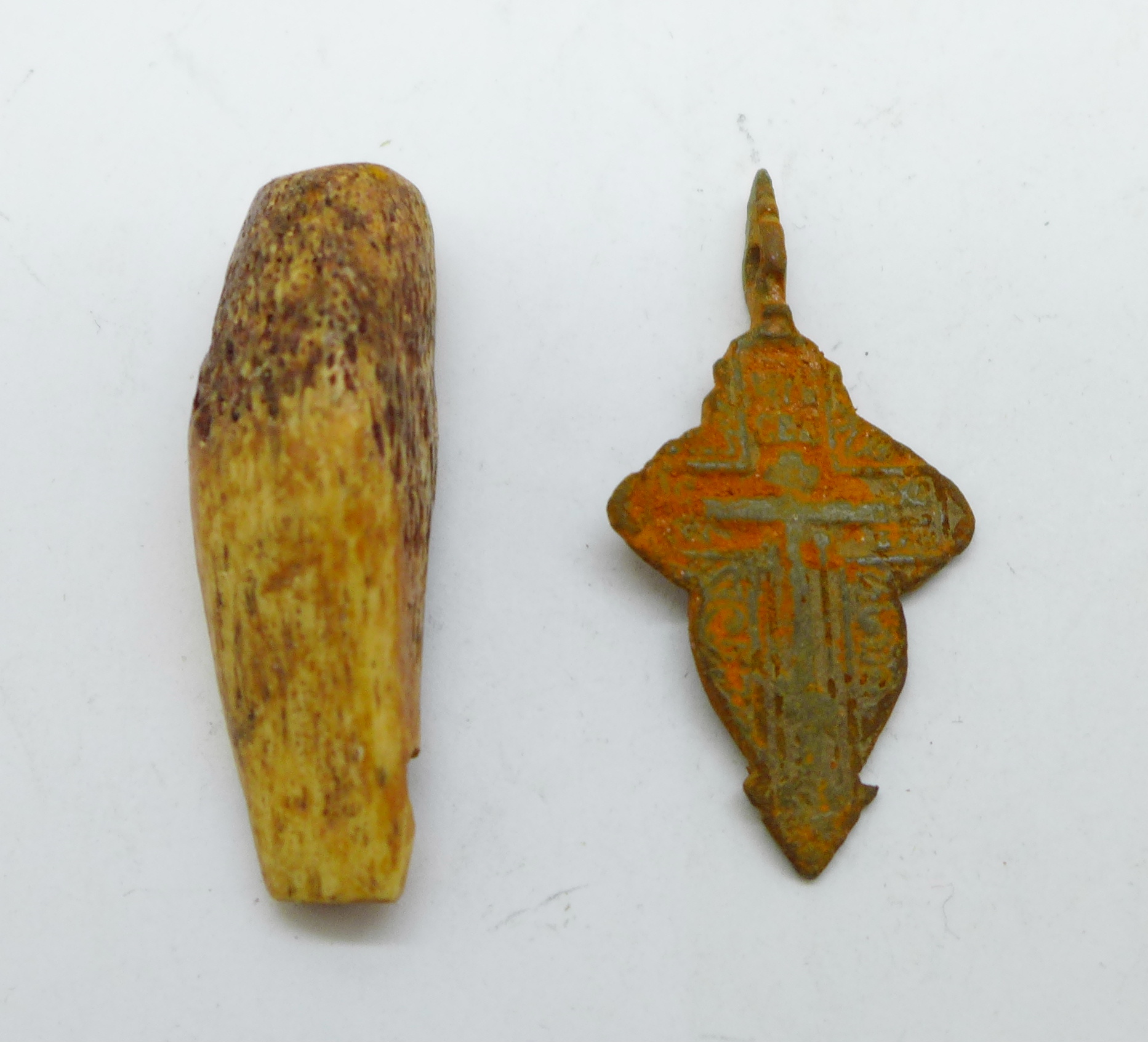 A bronze Viking cross and a bone amulet, found in Russia