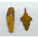 A bronze Viking cross and a bone amulet, found in Russia