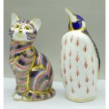Two Royal Crown Derby paperweights, penguin and cat with silver stopper