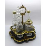 A Victorian five bottle cruet (one bottle replaced) on a papier mache stand