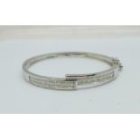 A 14ct white gold and diamond bangle, set with 124 square cut diamonds, 15.5g, (inner dimensions