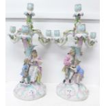 A pair of Dresden porcelain three branch candelabra, encrusted with flowers and leaves with