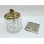 An Art Deco silver compact and a silver topped glass preserve jar, small chips to the rim of the