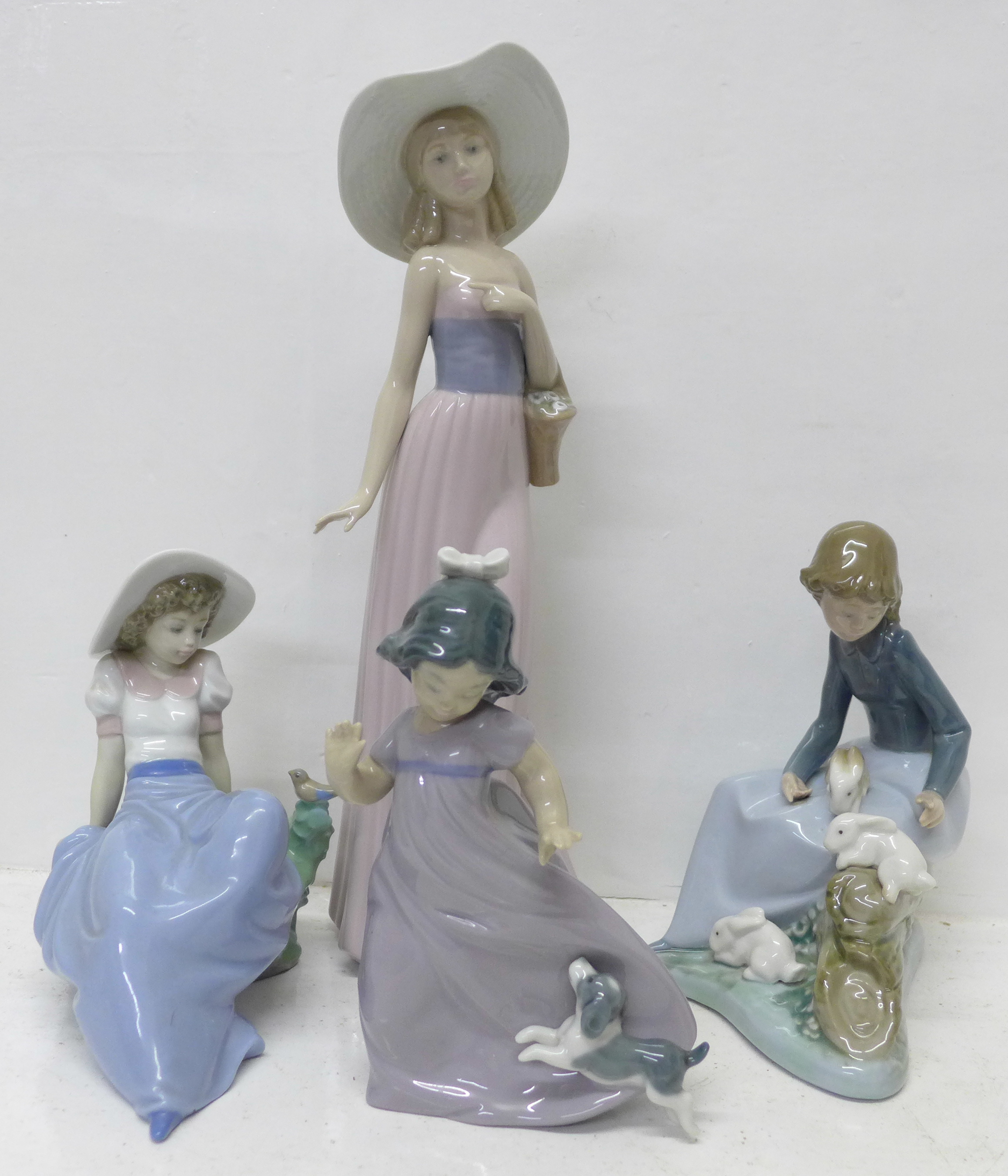 Four Nao by Lladro figurines. ?Listening to the Bird Song? (ref 02001042), ?Girl with Basket of