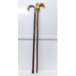 Two walking sticks, one with 'boot' handle