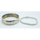 A silver bangle and a silver gem set tennis bracelet