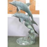 A brass verdigris sculpture of dolphins, 70cm