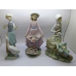 Three Lladro figures; Girl feeding a goose, Flower Curtsey and Girl with lamb and wheelbarrow