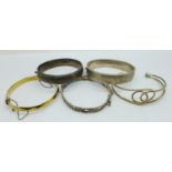 Four hallmarked silver bangles including one also marked '22ct on silver', and an open white metal