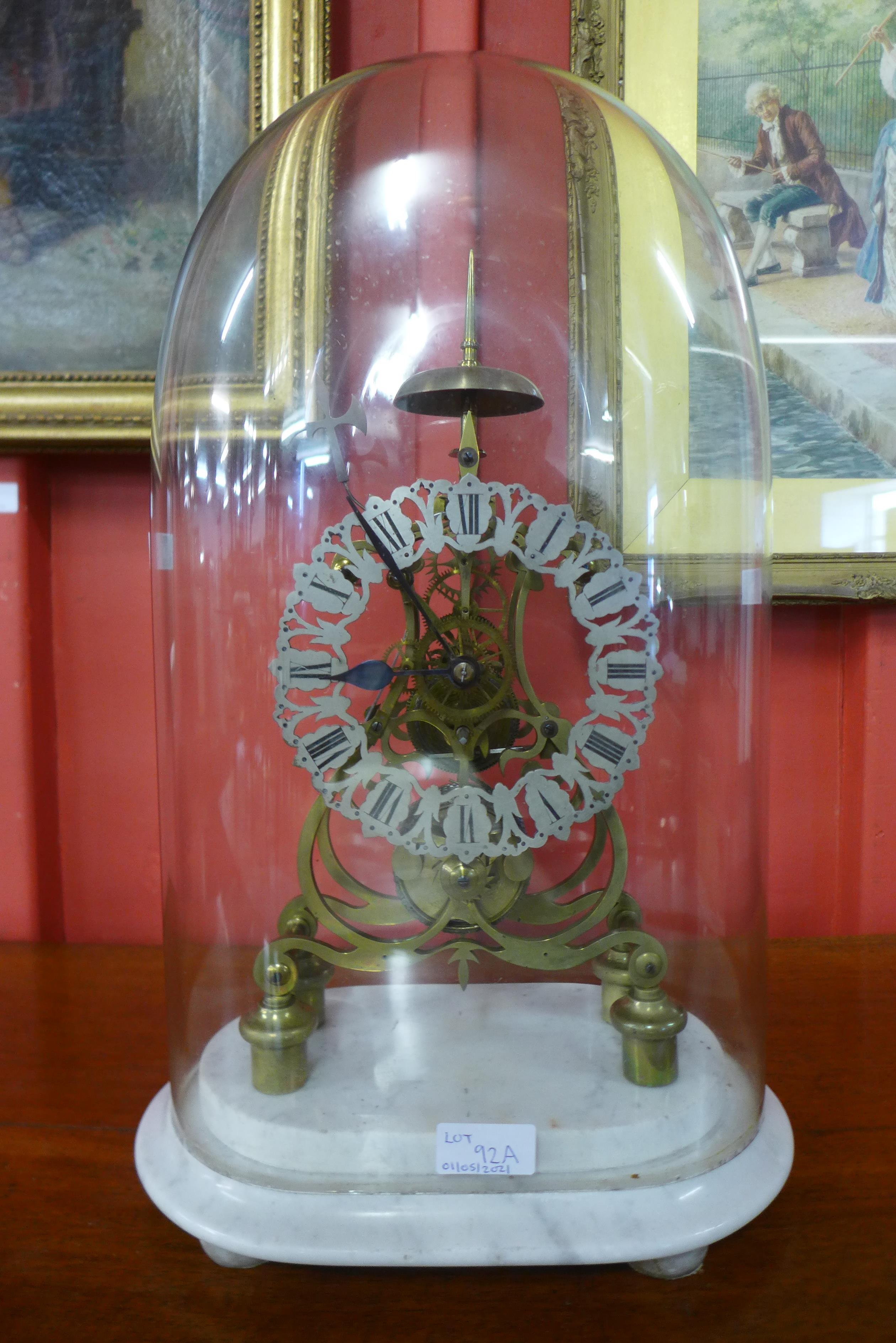 A Victorian glass domed brass five spoke wheel fusee skeleton clock, on marble base, 50cms h