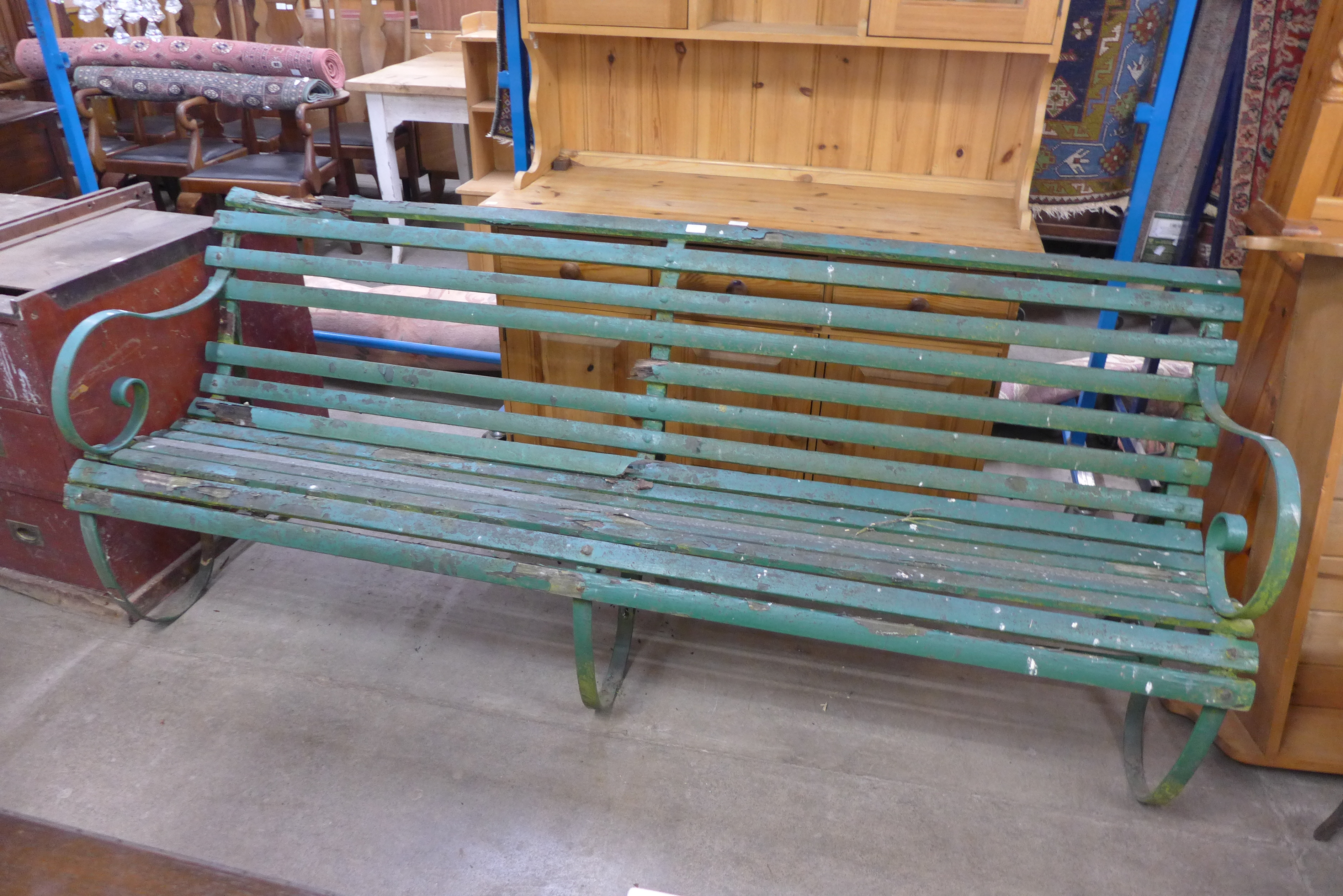 A Victorian pine and wrought iron garden bench