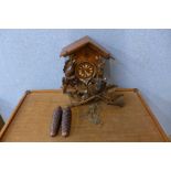 A Black Forest carved softwood cuckoo clock