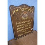 A painted H.M Courthouse sign