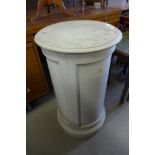 A painted cylindrical pot cupboard