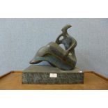 An abstract bronze sculpture of a seated lady