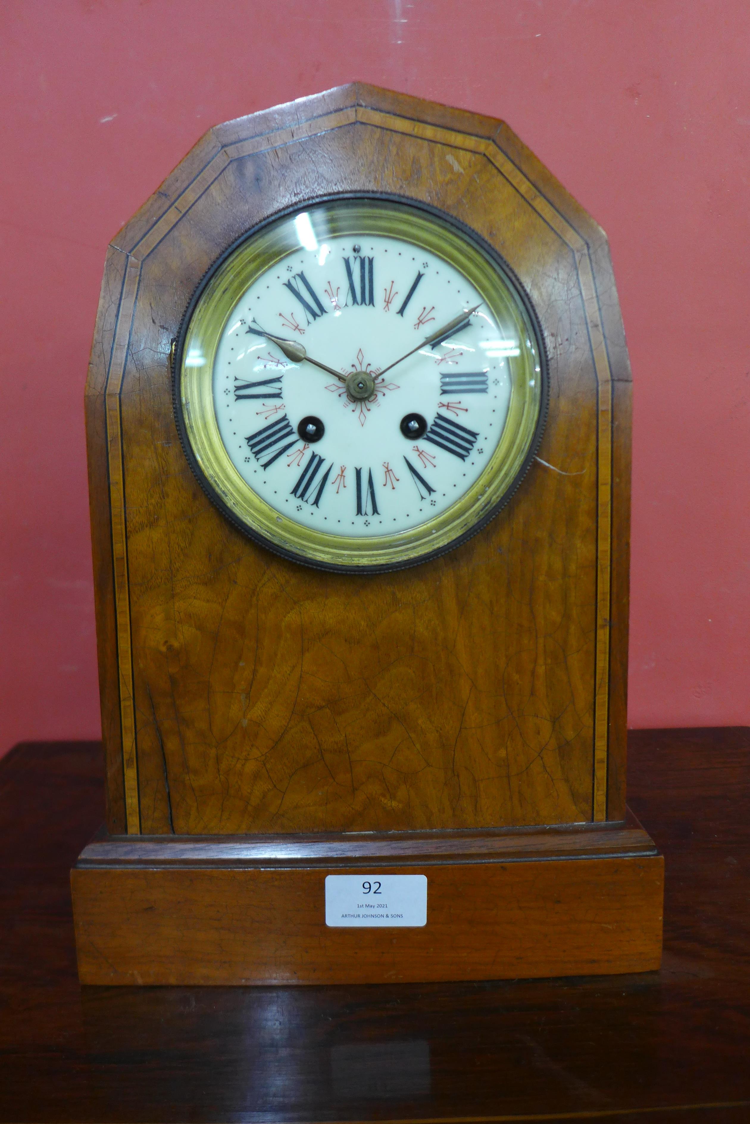 A 19th Century inlaid walnut lancet shaped mantel clock, the movement signed A.D. Mougin