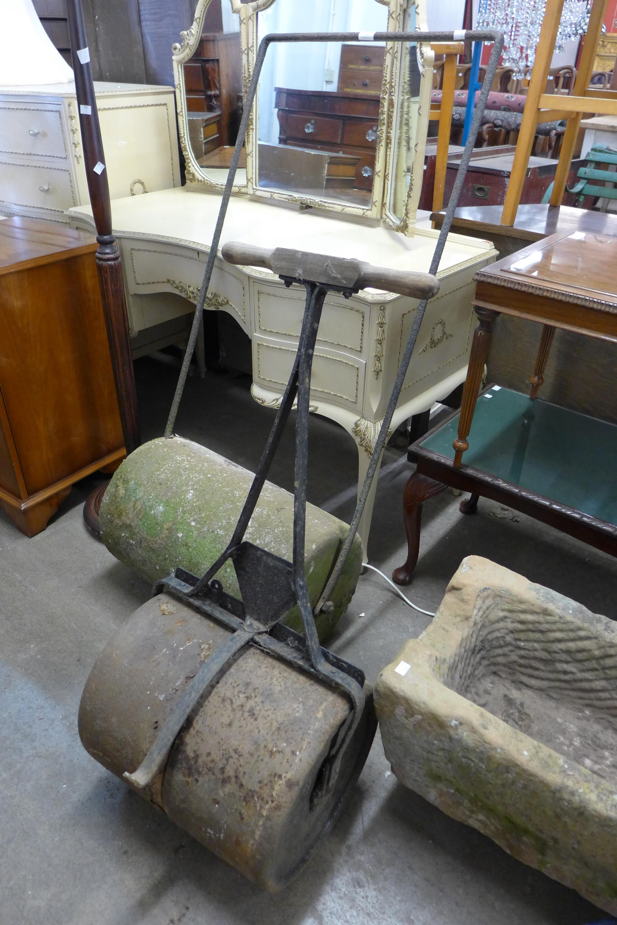 A Victorian wrought iron and stone garden roller and one other