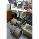 A Victorian wrought iron and stone garden roller and one other